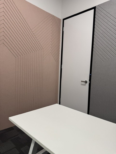 Blush and grey acoustic wall panels fitted around a doorway