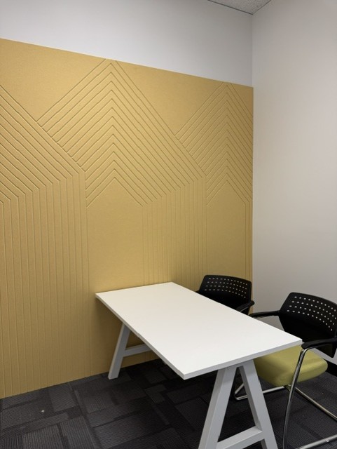 Gold acoustic feature wall in a consultation and meeting room