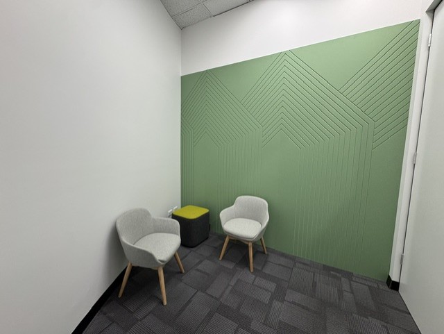 Green acoustic feature wall in a quiet consultation space