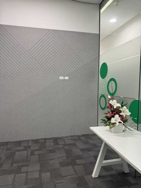 Custom grey acoustic wall panels with precision-cut geometric detailing
